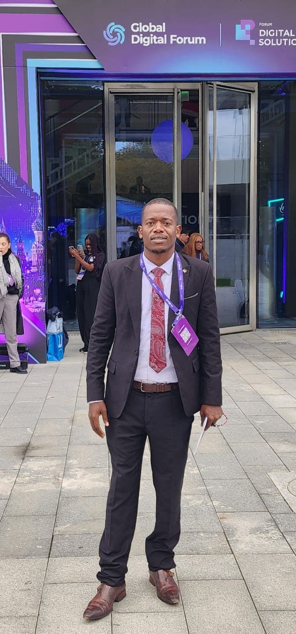 Mussollini Mugumbate at the entrance to the Global Digital Forum venue