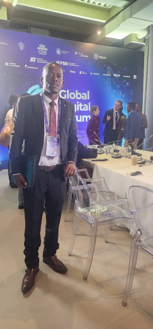 Mussollini Mugumbate standing in a Global Digital Forum meeting room